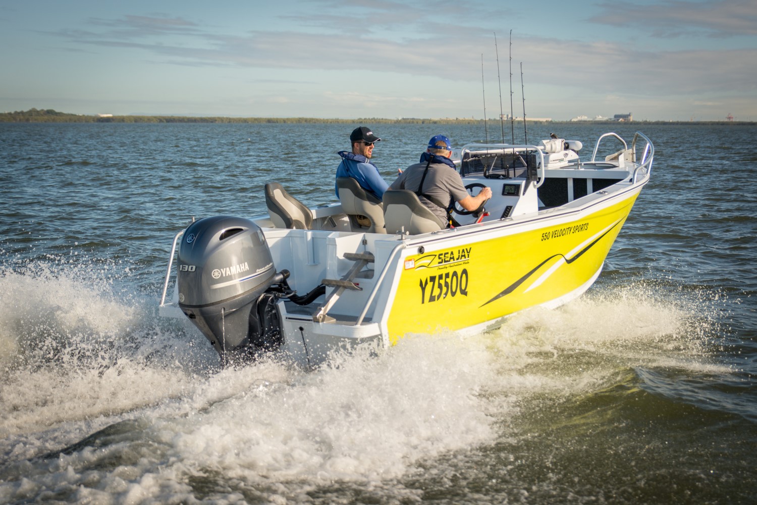 small yellow Sea Jay 550 Velocity boat  moving through the water